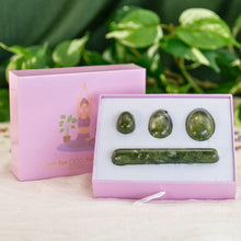 Load image into Gallery viewer, "A four-piece set of green flower jade yoni eggs. The crystals are laid in a light pink box that is propped up against its lid," - Down to Earth.