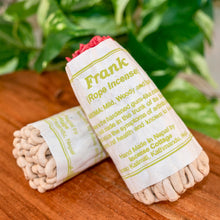 Load image into Gallery viewer, "Two rolls of frankincense rope incense on a wooden surface with greenery in the background," - Down to Earth.