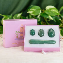 Load image into Gallery viewer, "An open light pink box is propped up against its lid, showcasing a four-piece green aventurine yoni egg set. These items are utilized in Kegel exercises to strengthen the pelvic floor," - Down to Earth.