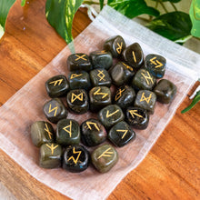 Load image into Gallery viewer, "Set of Labradorite Runes on a white organza bag with green foliage in the background," - Down to Earth.