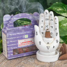 Load image into Gallery viewer, "Lavender Satya Backflow Dhoop Cones next to a Palmistry Incense Burner on a wooden plank with green foliage in the background," - Down to Earth.
