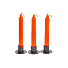 Load image into Gallery viewer, Front view of three orange ritual candles standing upright side by side. They are in black metal candle holders. - Down to Earth.