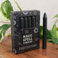 Load image into Gallery viewer, "Pack of 'Magic Spell Candles' with a single candle on a wooden surface, surrounded by green plants," - Down to Earth.