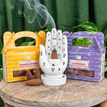 Load image into Gallery viewer, "Two packages of Satya Backflow Dhoop Cones in the scent variations sandalwood and lavender with a Palmistry Incense Burner between them," - Down to Earth.