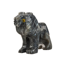 Load image into Gallery viewer, "Side angle view of a mini stone sculpture in the shape of a lion with yellow eyes," - Down to Earth.