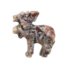 Load image into Gallery viewer, "Left side of a mini stone sculpture in the shape of a moose with yellow eyes," - Down to Earth.