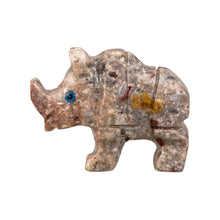 Load image into Gallery viewer, "Left side of a miniature stone rhino with blue eyes against a white background," - Down to Earth.