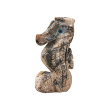Load image into Gallery viewer, "A stone figurine of a seahorse with blue eyes against a white background,' - Down to Earth.