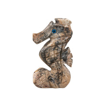 Load image into Gallery viewer, "Left side of a small stone figurine of a seahorse with blue eyes against a white background," - Down to Earth.