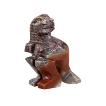 Load image into Gallery viewer, "Side angle of a stone-carved miniature in the shape of a tyrannosaurus rex," - Down to Earth.