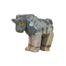Load image into Gallery viewer, "Stone sculpture of a unicorn with yellow eyes against a white background," - Down to Earth.