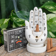 Load image into Gallery viewer, "Satya Super Hit Dhoop Cones next to a Palmistry Incense Burner on a wooden plank with green foliage in the background," - Down to Earth.