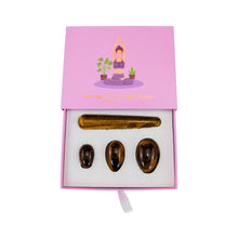 Load image into Gallery viewer, "Top-down view of an open yoni egg set in the crystal tiger's eye," - Down to Earth.