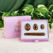Load image into Gallery viewer, "An open box of a tiger's eye yoni egg set propped up against its lid. These products are used in Kegel exercises to strengthen the pelvic floor," - Down to Earth.