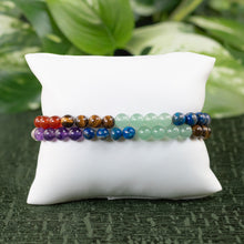 Load image into Gallery viewer, 6mm 7 Chakra Healing Bracelet on a pillow displayed on a styled background - Down to Earth
