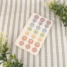 Load image into Gallery viewer, 7 Chakra Blank Notebook with white flower on a style background - Down To Earth 
