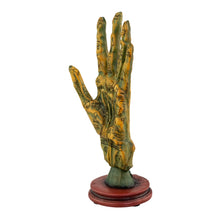 Load image into Gallery viewer, "Decorative hand sculpture with astrological symbols on a white background," - Down to Earth.
