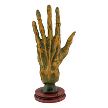 Load image into Gallery viewer, "Decorative hand sculpture with a wooden base on a white background," - Down to Earth.
