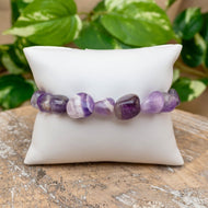 Amethyst Tumbled Stone Bracelet on White Pillow Styled Photo - Down To Earth