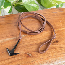 Load image into Gallery viewer, Anchor Wrap Leather Bracelet angled top down with plant on a styled background - Down To Earth
