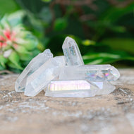 Angel Aura Quartz Crystal Point on a wooden surface low angle styled photo - Down To Earth