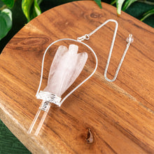 Load image into Gallery viewer, Angel Point Pendulum Rose Quartz on a wooden surface - Down to Earth
