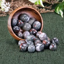 Load image into Gallery viewer, Bloodstone Tumbled 1lb front facing in a bowl displayed on a styled background - Down To Earth
