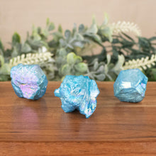 Load image into Gallery viewer, Blue Aura Quartz Point front facing on a style background - Down To Earth
