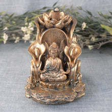 Load image into Gallery viewer, Bronze Buddha Backflow Incense Burner front facing with plants along with the incense cones on displayed on a styled background - Down To Earth
