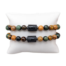 Load image into Gallery viewer, "Two Capricorn Zodiac Bracelets with the symbol and animal that represents the sign on a white pillow," - Down to Earth.
