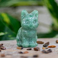 Green Aventurine Cat Statue on a wooden surface styled photo - Down to Earth