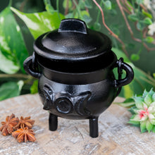 Load image into Gallery viewer, Cast Iron 3" Triple Moon Goddess Cauldron on a wooden surface styled photo side angle - Down to Earth
