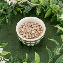 Load image into Gallery viewer, Ceridwen's Herbs High John Root angled in a bowl displayed on a styled background - Down to Earth
