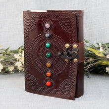 Load image into Gallery viewer, Chakra Stone Leather Journal angled front facing with flowers displayed on a styled background - Down To Earth
