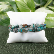 Load image into Gallery viewer, Chrysocolla Tumbled Bracelet on a pillow displayed on a styled background - Down to Earth
