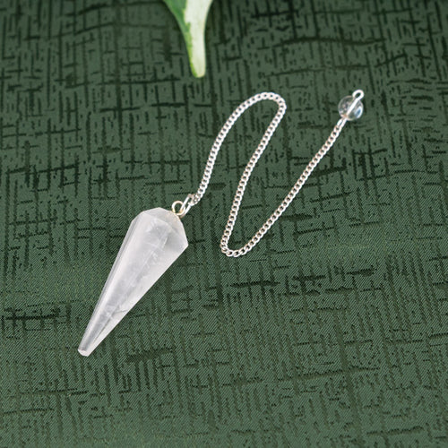 Clear Quartz Pendulum on a green cloth - Down to Earth