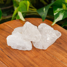 Load image into Gallery viewer, Clear Quartz Raw on a wooden surface - Down to Earth 
