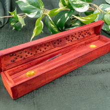 Load image into Gallery viewer, &quot;Cherry-red Triangle Coffin Incense Burner on a green cloth with foliage in the background,&quot; - Down to Earth.
