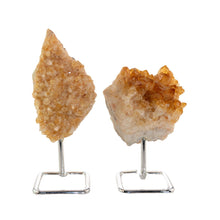 Load image into Gallery viewer, "Two Druze Citrine raw crystals on a silver stand on top of a white background," - Down to Earth.
