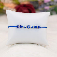 Load image into Gallery viewer, Dark Blue Evil Eye Bracelet Knotted on a Pillow - Down To Earth
