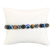 Load image into Gallery viewer, Evil Eye Crystal Bracelet on a pillow displayed on a white background - Down To Earth
