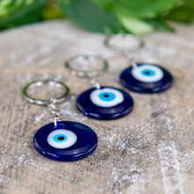 Load image into Gallery viewer, Evil Eye Key Chain on a wooden surface - Down to Earth 
