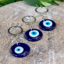 Load image into Gallery viewer, Evil Eye Key Chain on a wooden surface - Down to Earth 
