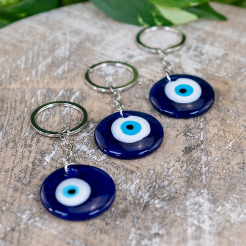 Evil Eye Key Chain on a wooden surface - Down to Earth 