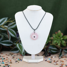 Load image into Gallery viewer, Evil eye pink varient necklaces on a white mannequin neck against a green background - Down to Earth
