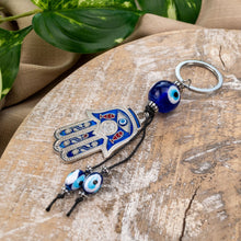 Load image into Gallery viewer, Evil Eye Hamsa Keychain Styled Photo - Down To Earth
