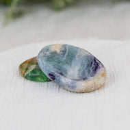 Fluorite Calming Stones on a white cloth - Down to Earth 