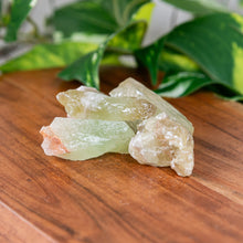 Load image into Gallery viewer, Green Calcite Raw 1lb on a wooden surface - Down to Earth
