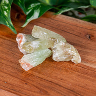 Green Calcite Raw 1lb on a wooden surface high angle - Down to Earth