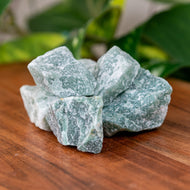 Green Quartz Raw on a wooden surface - Down to Earth 